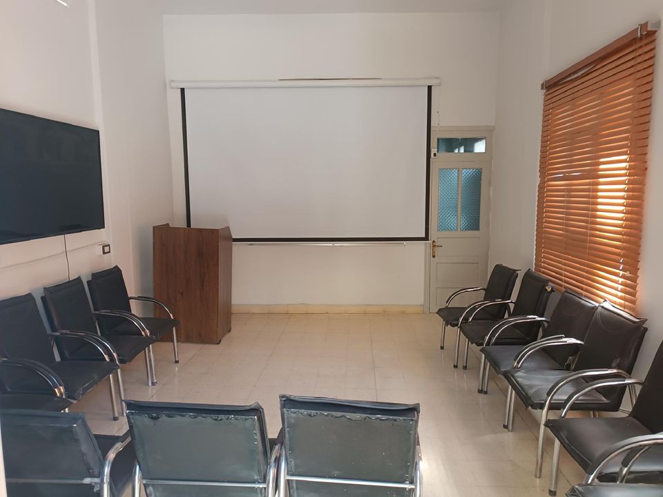 A training and workshop room with tables and chairs