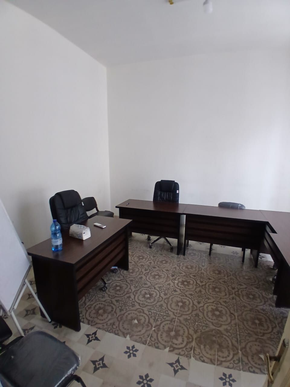 Small office with a desk and chairs